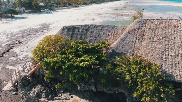 The Rock Restaurant in Ocean Built on Cliff at Low Tide on Zanzibar Aerial View alt