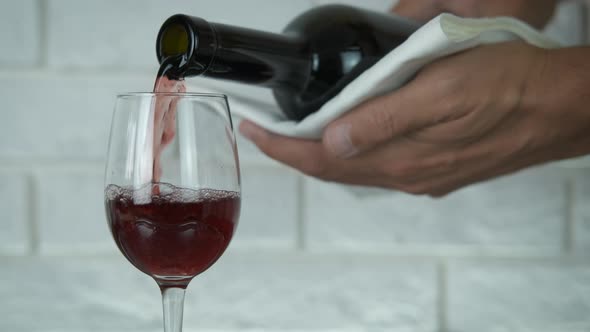 Wine is poured into a wine glass. alt