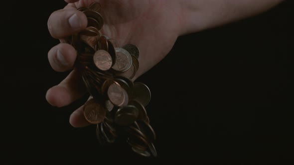 Hand dropping coins in slow motion; shot on Phantom Flex 4K at 1000 fps alt