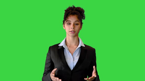 African American Woamn in a Black Jacket Talking on Camera on a Green Screen Chroma Key alt