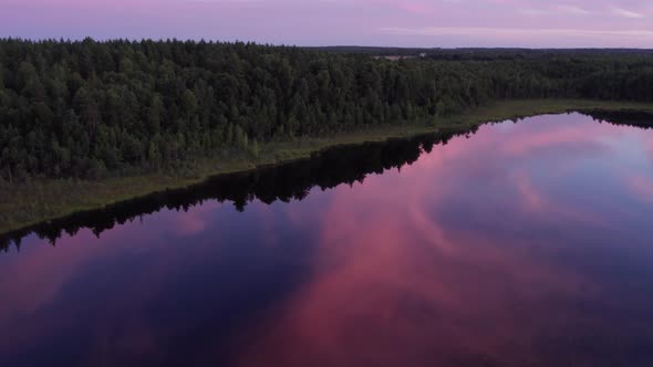 Aerial photography of the lake swamp from a drone at sunset with beautiful sun flares. reflection of alt