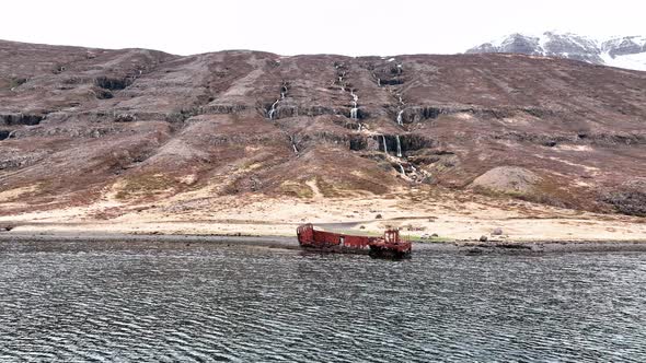 Abandoned Shipwreck In Mjoifjordur, East Iceland - aerial forward alt