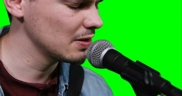 Close-up of singer singing songs on microphone alt
