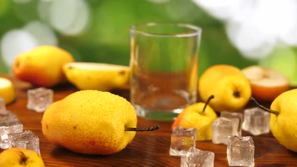 Pear Juice Poured Into Glass and Fruits on Table