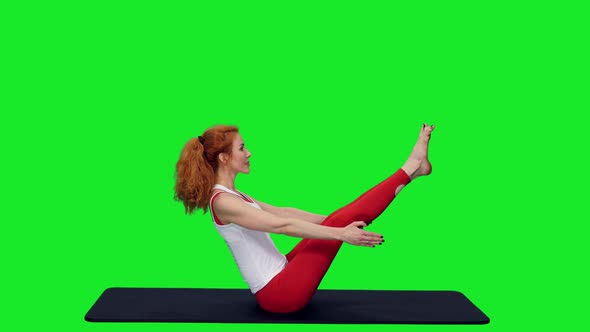 Flexible Fit Woman In V Sit Posture Doing Yoga On Green Screen Background