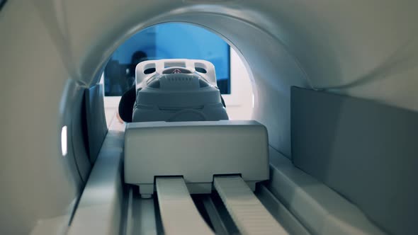 A Person Is Moving Into an MRI Machine alt