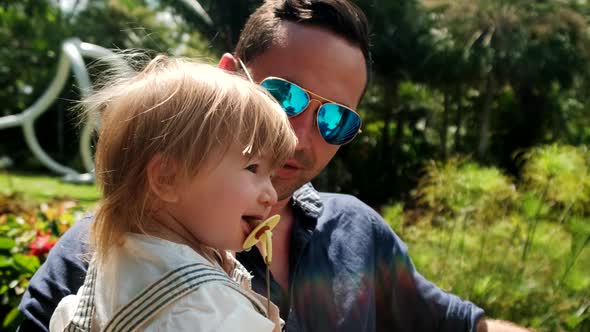 Happy Father and Daughter Playing in Park alt