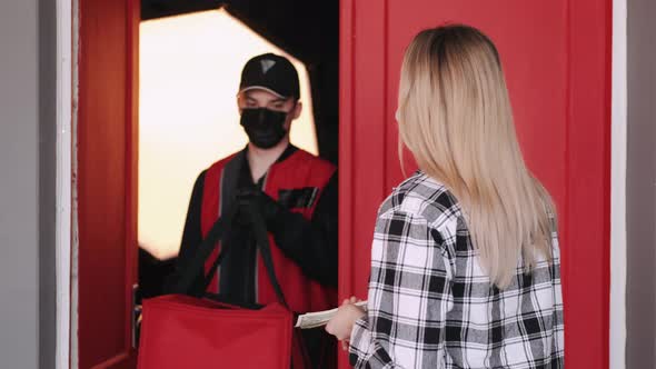 Pizza Delivery Man Is Giving an Order and Woman Is Paying in Cash alt