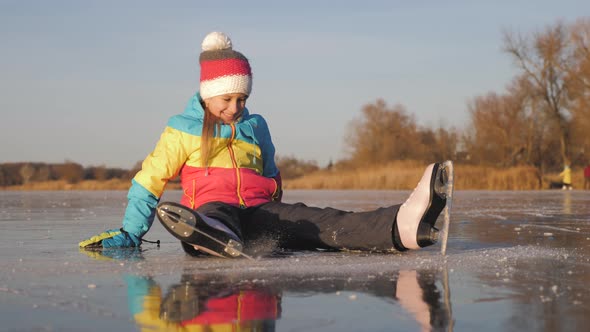 A Little Girl Enjoying Ice Skating at Frozen Lake in Winter Season. Winter Sports alt