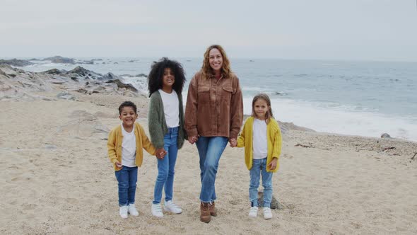 Portrait of Mom with Three Children On Beach