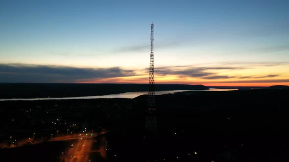 View From the Drone of a Beautiful Sunset with a River and a Television Tower at Sunset. High