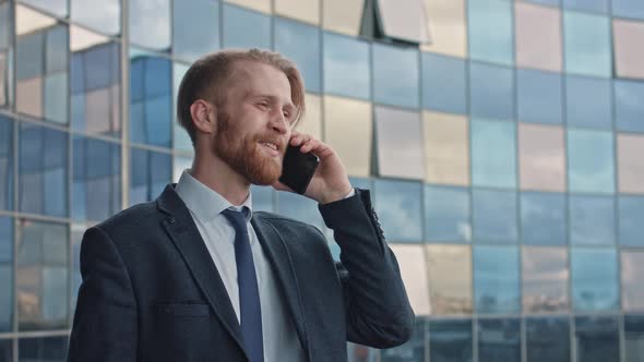 Middle Age Attractive Businessman Using Smartphone and Speaking with His Investors