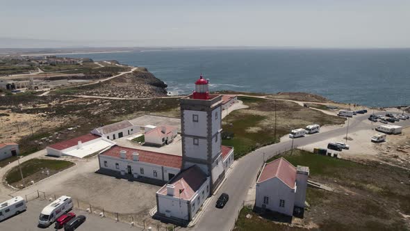 Lighthouse of Cape Carvoeiro in Peniche, sea and coastline of Portugal. Aerial pullback