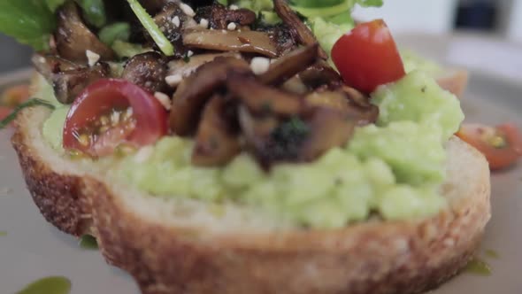 Vegan Plant Based Healthy Avocado Toast with Mushroom Cherry Tomatoes and Rucola alt