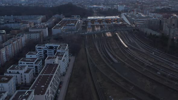 Aerial View of a Passenger Train Passing By Trees in Berlin Germany Surrounded By Residential House alt