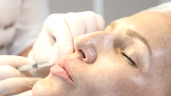 Middleaged Woman Getting Botox Injections alt