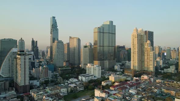Bangkok skyline during golden hour with clear blue skies, aerial view alt