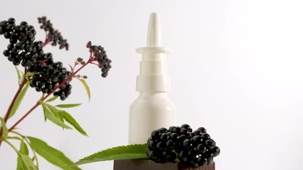 Nasal Spray With A Black Berry On A White Background, Homeopathic Treatment,Elderberry Medical Nasal alt