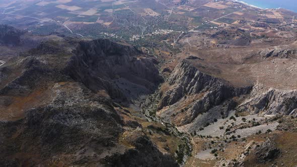 Aerial view from above Mountain. Flying above gorge in Greece. Fly over wild nature 