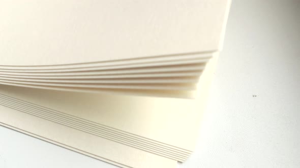 4k video, close-up of a stack of paper, blank white sheets flipping and counting