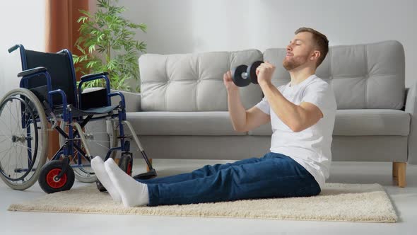 Disabled Athlete Performs Exercises with Dumbbells on Wheelchair Background alt