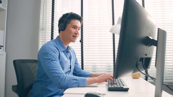 Asian businessman use laptop computer video call with office colleague. alt