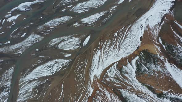 Drone Flight Over Landscape With Snow On Braided River alt