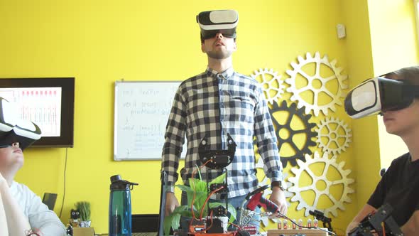 Male Teacher and Students in VR Glasses at Lesson