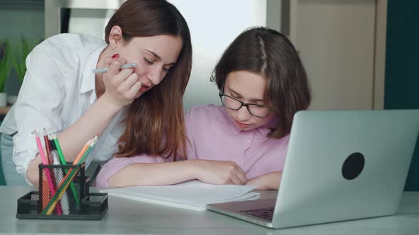 Teacher and Kid at Home Doing Homework Online alt