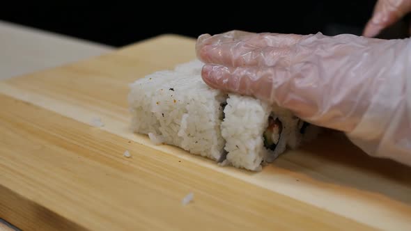 the Sushi Chef Cut the Blank Into Rolls with a Knife and Folded Them Evenly
