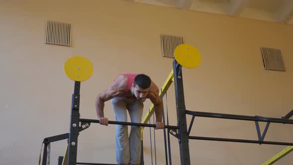 Young Athlete Doing Handstand on Horizontal Bar at Gym alt