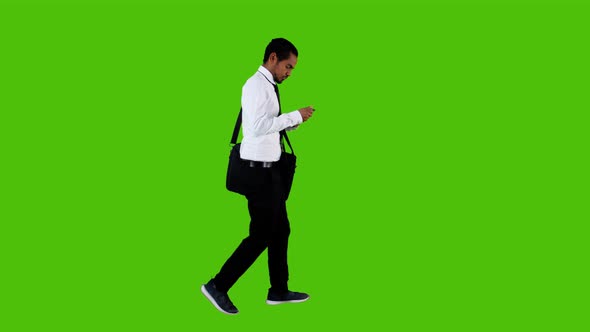 answering a call happily while walking by a young businessman, green screen.4K alt