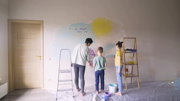 Concentrated Mother Helps Children To Colour Flat Wall