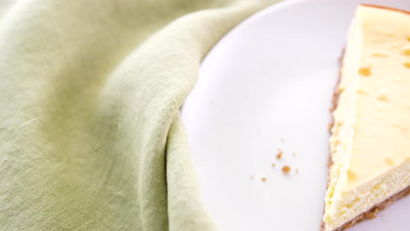 Pouring Raspberry Sauce Over Cheesecake alt