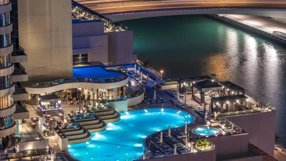 View of Skyscrapers with Swimming Pool in Dubai Marina Timelapse alt