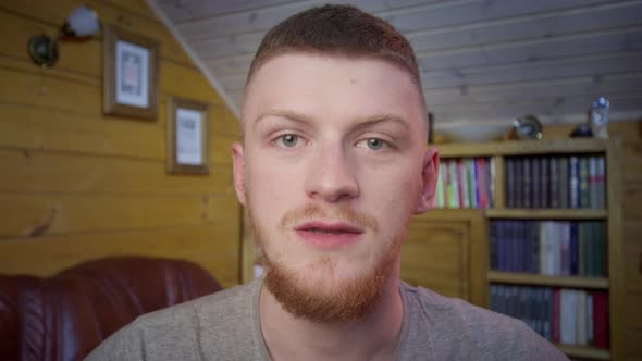 Confident Redhead Man Vlogger Look at Camera Talk Using Computer App Webcam View alt