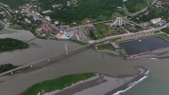 Anaklia, Georgia - July 16 2022: Aerial view of Anaklia-Ganmuhkuri Pedestrian Bridge at sunset alt