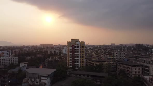 Drone moving towards a building in India during sunset