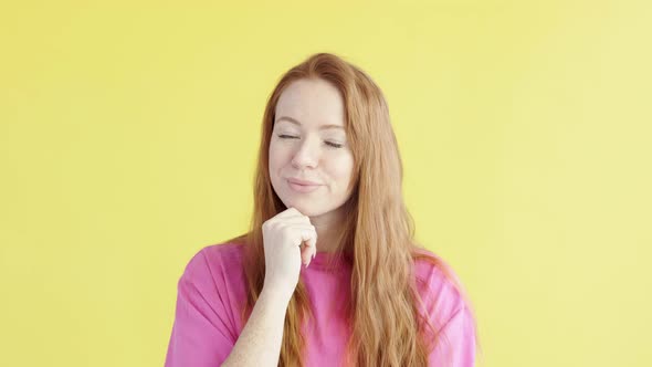 woman looks around thoughtfully on yellow isolated background.