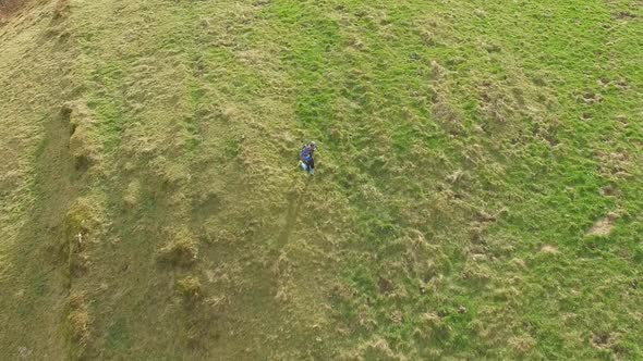 Aerial view of a trail runner running on grass alt