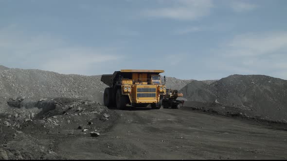 Industrial Transport Traffic in Coal Pit Crawler Excavator Crane Dump Truck