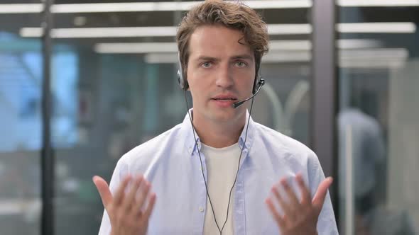 Portrait of Man Talking on Headset alt