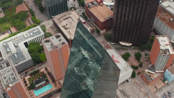 High Angle View of Sharp Ridge on Top of Tall Glass Covered Unusual Shape Building alt