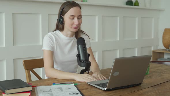 Woman with Microphone and Laptop Computer Talking and Recording Podcast at Studio alt