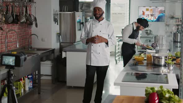 African American Cook Filming Cooking Show Vlog on Camera alt