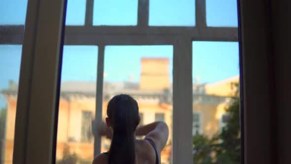 Woman Cleaning Windows Using Sprayed Liquid Cleaning for Wipe Glass Tidy Up