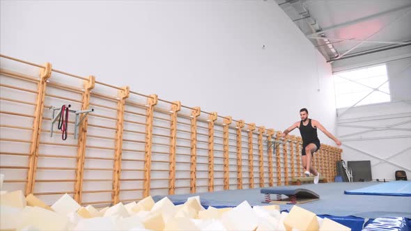 Athlete Runs Up Jumps on Acrobatic Trampoline Does a Front Flip Slow Motion alt