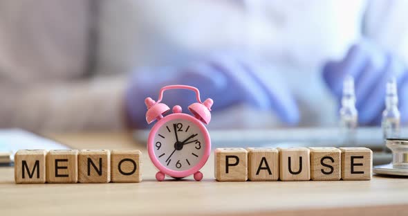 Word Menopause on Cubes and Doctor Gynecologist in Clinic alt