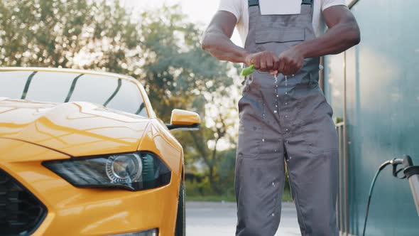 Crop Close Up of Handsome Bearded Young African Guy Worker Unscrews a Rag on a alt