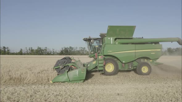 Combine Harvesting Wheat Top View of a Wheatfield alt